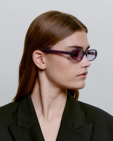 Ovale lilla A.Kjærbede solbriller med lilla linse - fra siden på kvindemodel